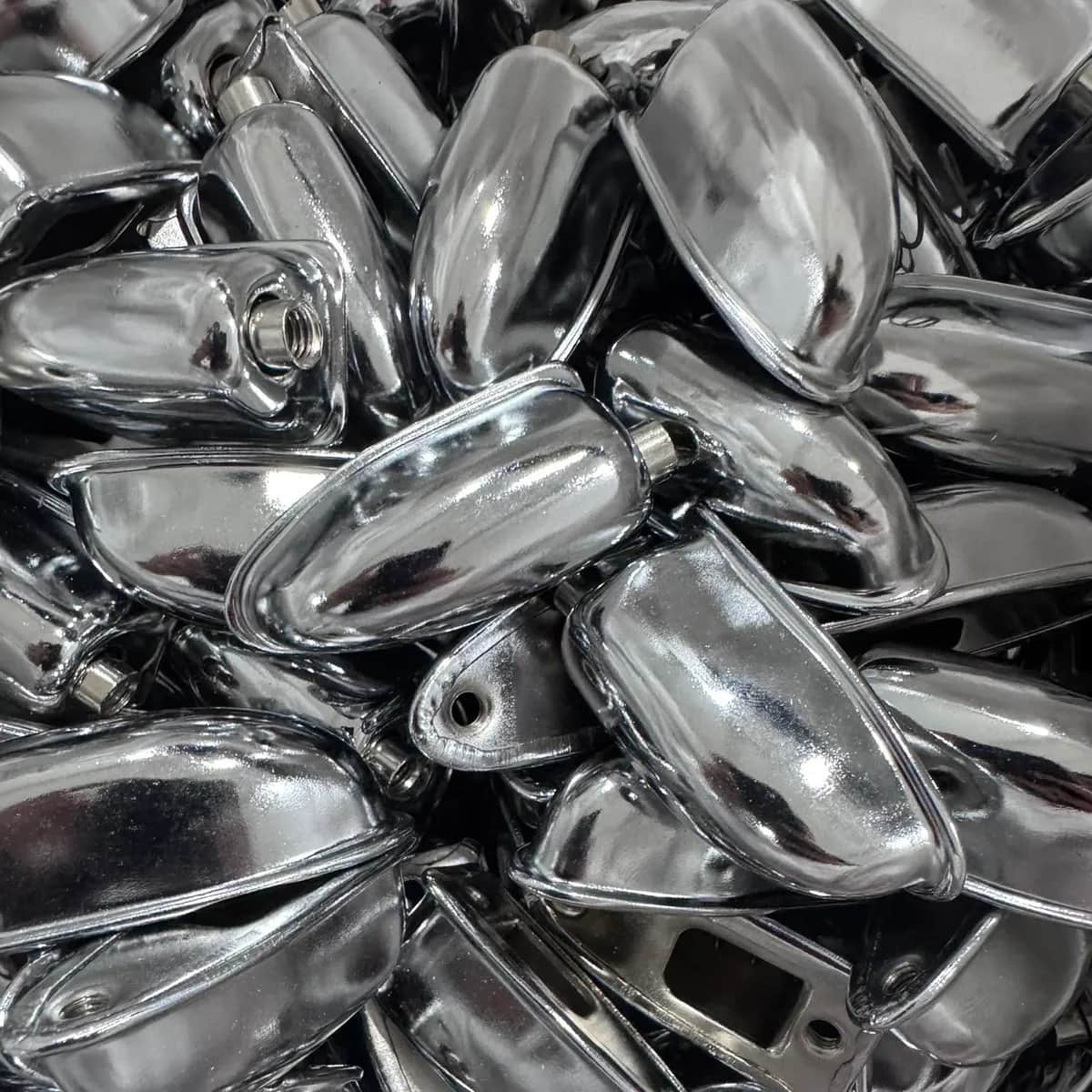 A pile of chrome drum lugs